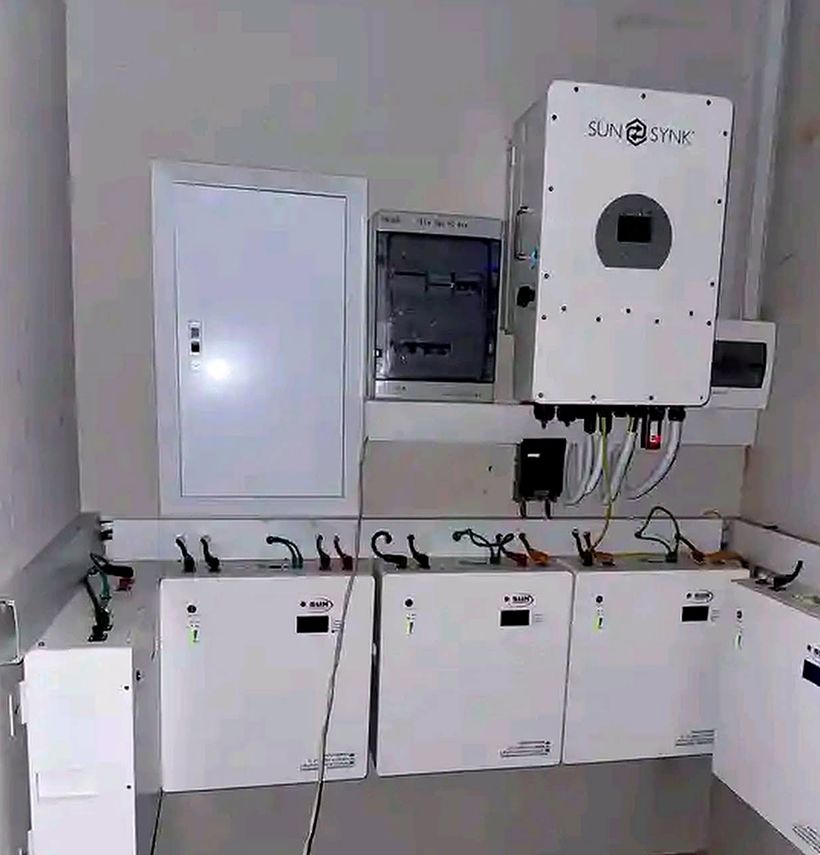 Hybrid inverter and wall-mounted lithium batteries in a plant room