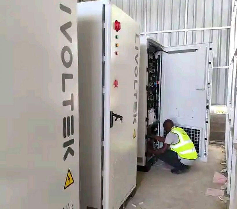 Technician working inside Livoltek commercial battery storage cabinets